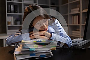 Company employees working overtime after work, working overtime after working hours due to heavy workload, employees are stressed