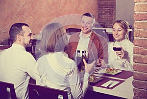 Company of friends eating delicious dinner