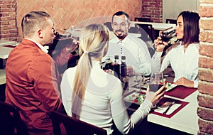 Company of friends eating delicious dinner