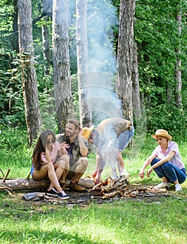 Company friends picnic or barbecue roasting food near bonfire. Best friends spend leisure weekend hike barbecue forest