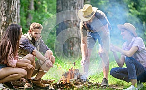 Company friends prepare roasted marshmallows snack nature background. Camping activity. Roasting marshmallows popular