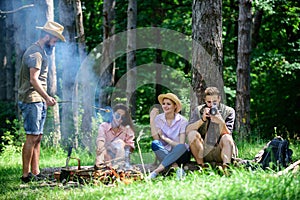 Company hikers relaxing at picnic forest background. Spend great time on weekend. Take a break to have snack. Company