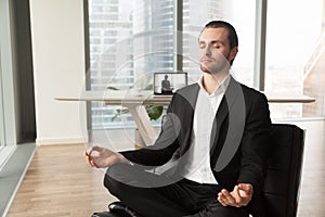 Company leader practices yoga during break at work