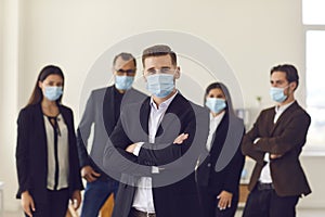 Company manager and employees care about clients and colleagues wearing face masks at work