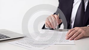 Company president reading contract, signing important cooperation agreement