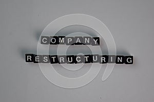 Company Restructuring on wooden block isolated on table