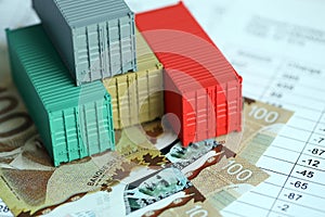 Company shipping cargo containers in Canada with dollar money bills and pen