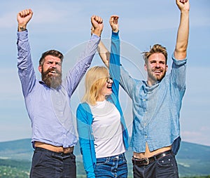 Company three happy colleagues office workers enjoy freedom, sky background. Employees enjoy feeling of freedom. Freedom