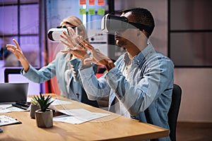 Company workers wearing VR headset during meeting