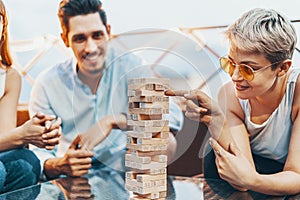 The company of young people playing jenga