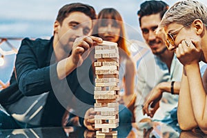 The company of young people playing jenga