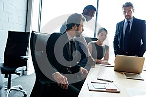 This companys success is owed to its staff. a group of executives having a meeting in a boardroom.