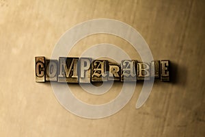 COMPARABLE - close-up of grungy vintage typeset word on metal backdrop photo