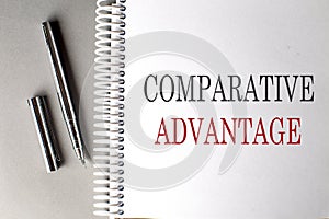 COMPARATIVE ADVANTAGE text on a notebook with pen on grey background