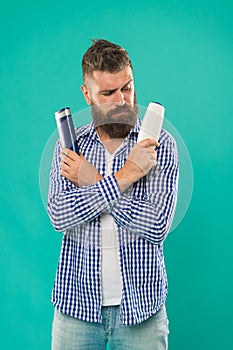 Compare beauty product. Wash hair with shampoo. Hair conditioner or lotion. Make right choice. Man bearded hipster