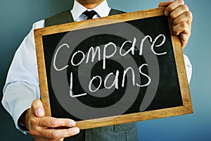 Compare loans inscription on a blackboard