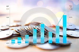 Comparison bar chart numeric data stock market with blur coin cash and bokeh background. plan investment income and saving money