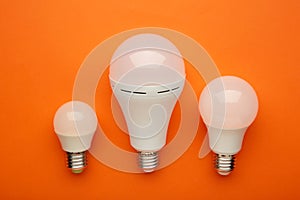 Comparison of different light bulbs on orange background