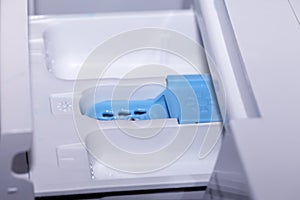 Compartments to put the detergent softener and bleach in an automatic clothes washer