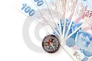 Compass and 100 turkish lira close-up. to use Turkish lira for economy and investment, correct and accurate investment