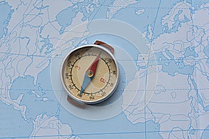 compass on the background of a contour map. journey. geography. north-south concept