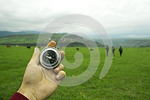 Compass on a background of green field