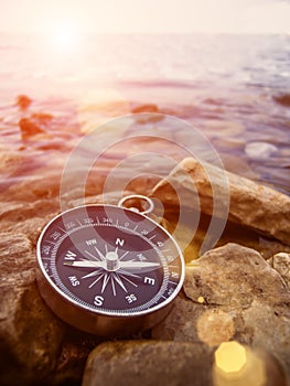 Compass on the bank with sun flare