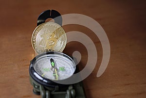 Compass and Bitcoin with copy space photo