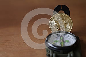 Compass and Bitcoin with copy space photo