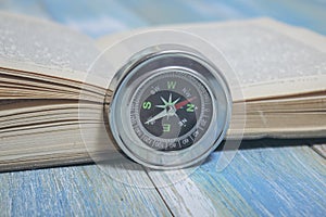 compass and book on the table