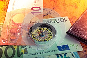 Compass,  box, wallet and Euro banknotes  on an old map