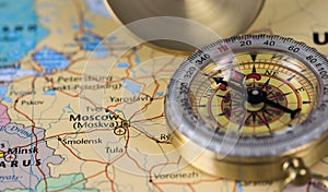 Compass on a close up map pointing at Moscow and planning a travel destination.