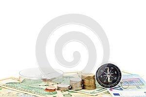 Compass and coins on money banknotes Euro and Dollars,concept of