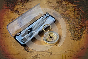compass or dividers on old world map. Travel,