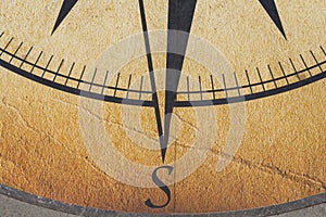 The compass is drawn on a concrete slab