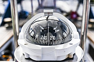 A compass, a front view from on a sailing yacht.