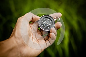 Compass in a hand at the jungle.