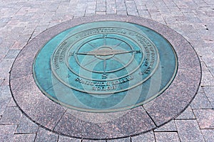 A compass lists the directions to nearby landmarks on Capitol Hill in Washington DC - image