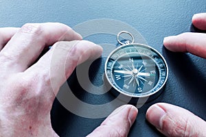 Compass lying on a blue office desk. Concept for business and creativity