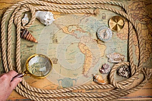 Compass, magnifier and rope on vintage map