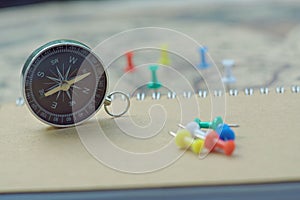 Compass and notebook on blur vintage world map, journey concept, copy space