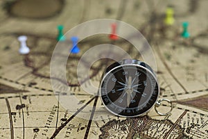Compass and notebook on blur vintage world map, journey concept, copy space