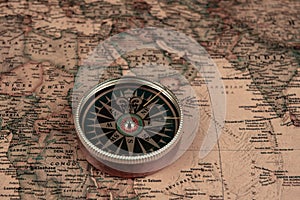 Compass on old map of the world. Journey and discovery concept