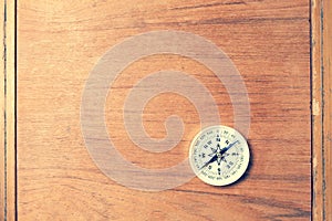 compass on old wood background with copy space for text.