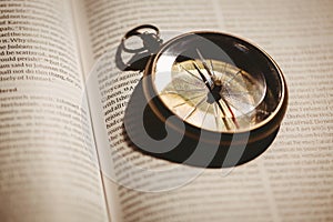Compass on open bible