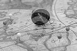 Compass and pin point marking with vintage map background