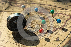 Compass and pin point marking with vintage map background