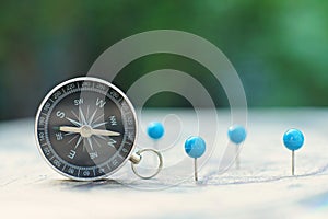 Compass and pin point marking with vintage map background