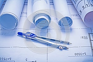 Compass and rolled up bluprints