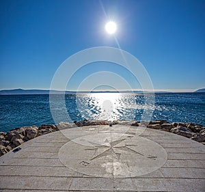 Compass by the sea